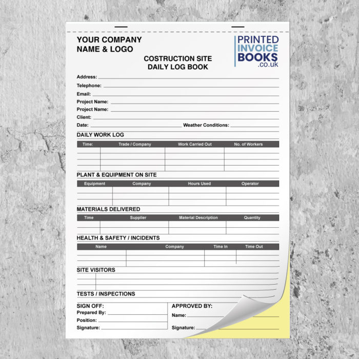 Close-up of a custom construction site daily log book showing the white top sheet and yellow duplicate copy with a top perforation line.